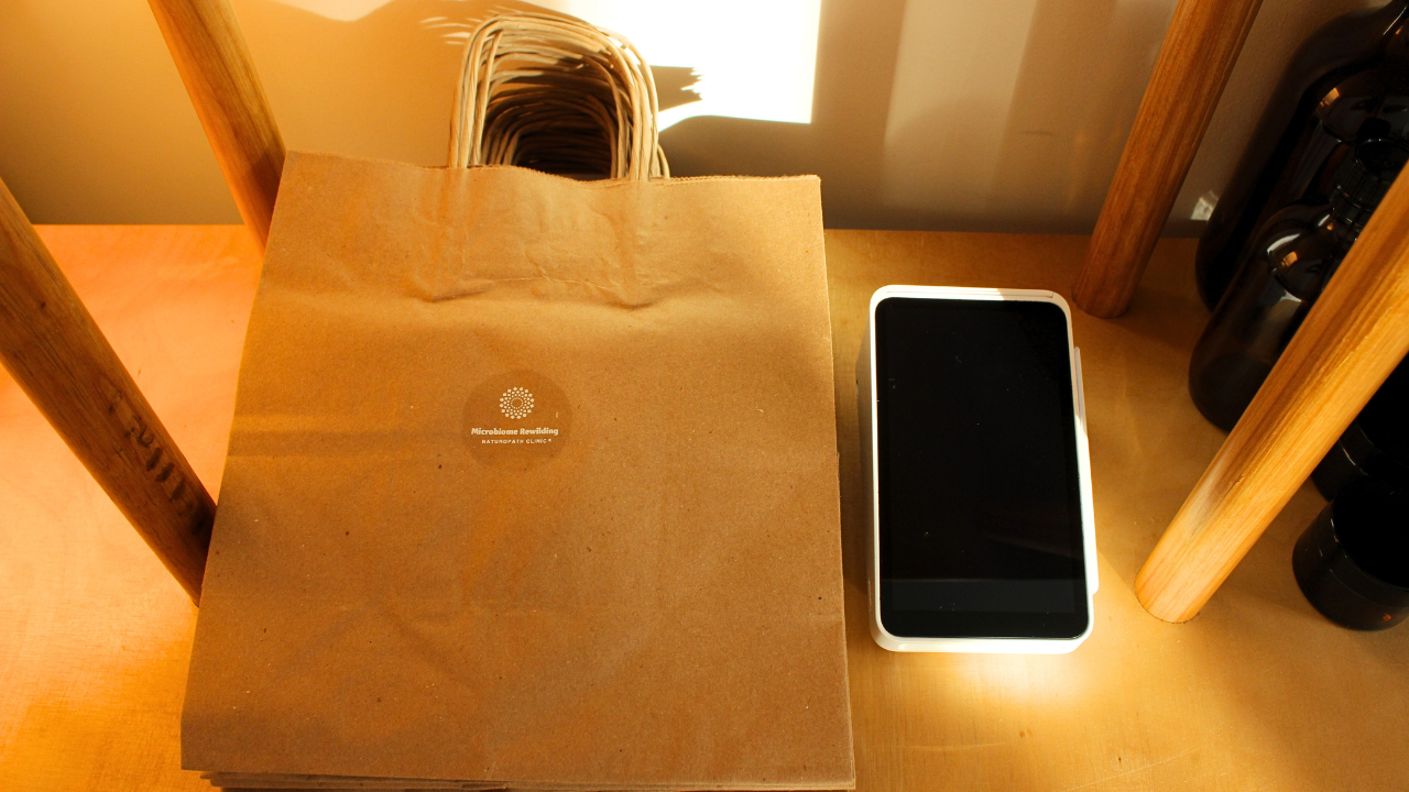 Microbiome Rewilding Naturopath Clinic Brisbane Australia Online Appointments Personalised holistic health for women Naturopath Dispensary Shelves with various herbal medicine bottles and skincare containers in a well-lit room